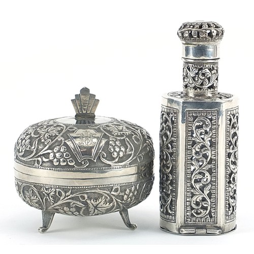 2223 - Middle Eastern silver bottle case with glass bottle and a circular silver box and cover embossed wit... 