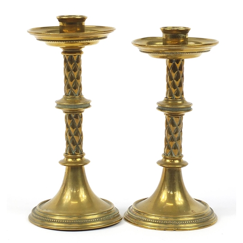 755A - Two Arts & Crafts brass candlesticks by William Tonkin & Son, the largest 21.5cm high