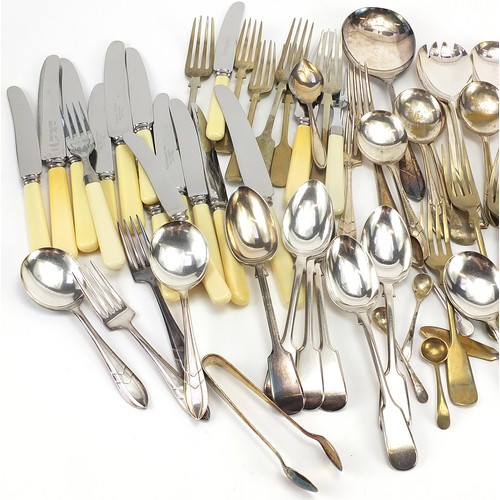 1196A - Silver plated and stainless steel cutlery, some with ivorine handles and a pair of silver sugar tong... 