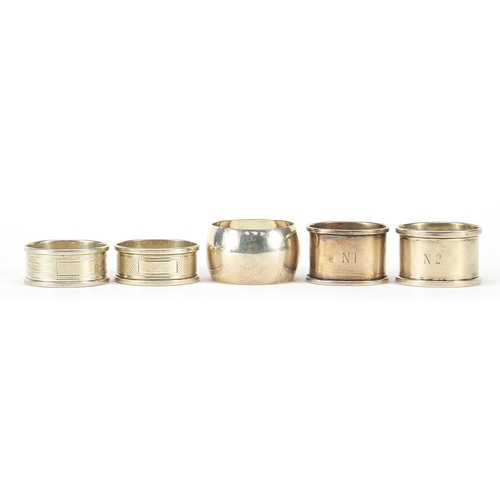 568 - Five Edwardian and later circular silver napkin rings, various hallmarks, each approximately 4.5cm i... 