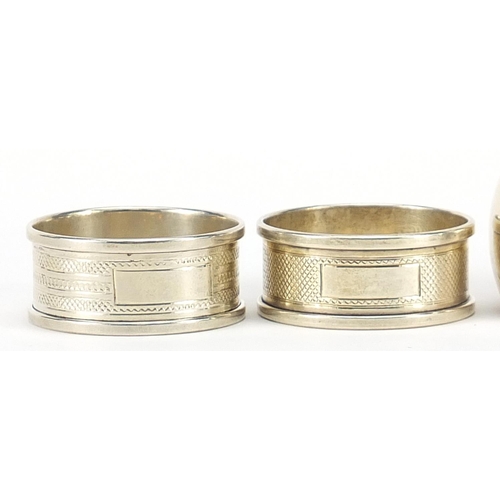 568 - Five Edwardian and later circular silver napkin rings, various hallmarks, each approximately 4.5cm i... 