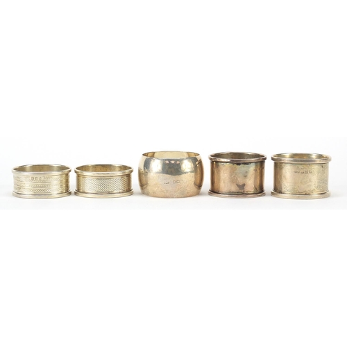 568 - Five Edwardian and later circular silver napkin rings, various hallmarks, each approximately 4.5cm i... 