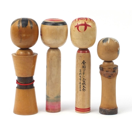 592 - Four Japanese Kokeshi dolls, the largest 31cm high