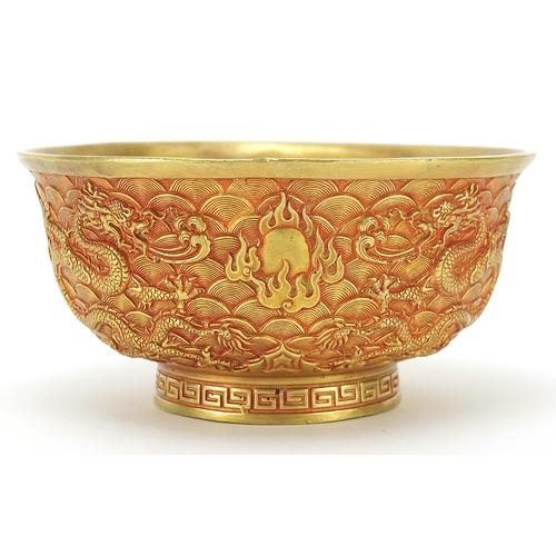 595 - Chinese gilt bronze footed bowl cast with dragons amongst clouds chasing flaming pearls, four figure... 