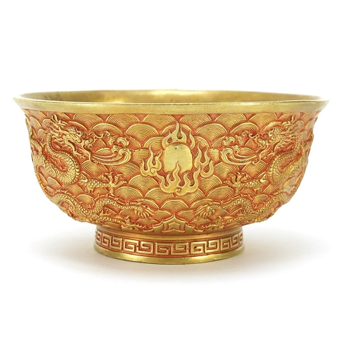 595 - Chinese gilt bronze footed bowl cast with dragons amongst clouds chasing flaming pearls, four figure... 