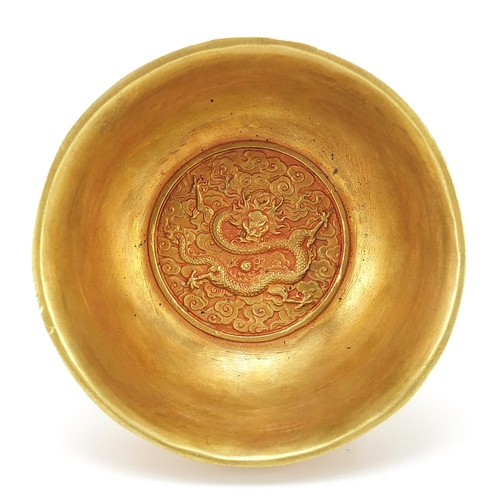 595 - Chinese gilt bronze footed bowl cast with dragons amongst clouds chasing flaming pearls, four figure... 