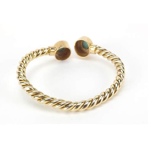 1425 - Unmarked gold rope twist and cabochon turquoise bangle, (tests as 15ct+ gold) 6.5cm wide, 13.5g