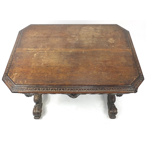 832A - Oak centre table with frieze drawer, carved with lion heads and dolphin feet, 74cm H x 102cm W x 71c... 