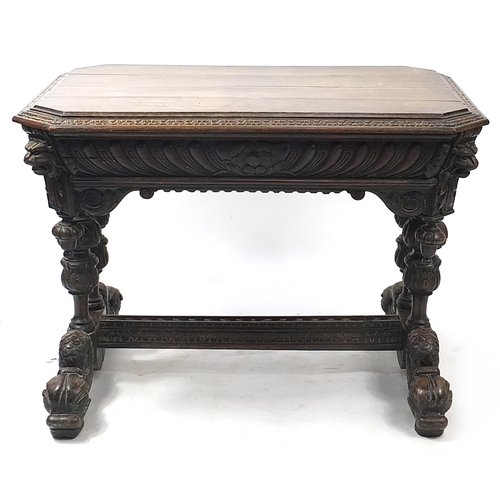 832A - Oak centre table with frieze drawer, carved with lion heads and dolphin feet, 74cm H x 102cm W x 71c... 