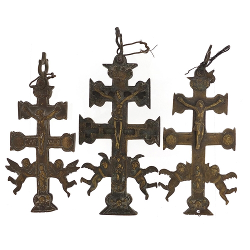 589 - Three Spanish bronzed crucifixes, the largest 13cm high