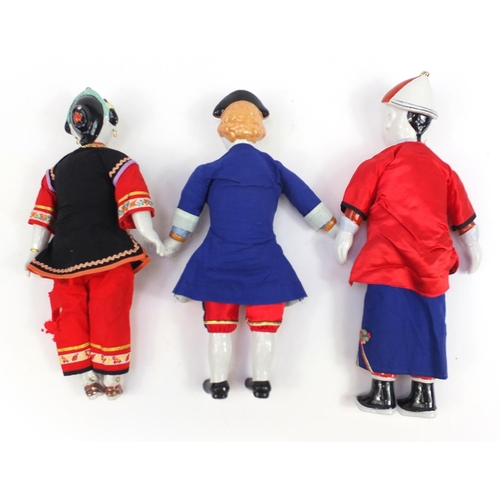 865 - Three Chinese porcelain dolls with cloth bodies and tapestry clothing, the largest 41cm high