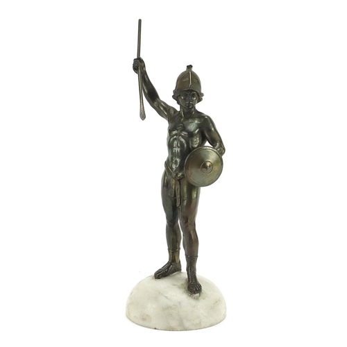 599 - Bronzed spelter figure of a Roman gladiator raised on a white marble base, 24cm high