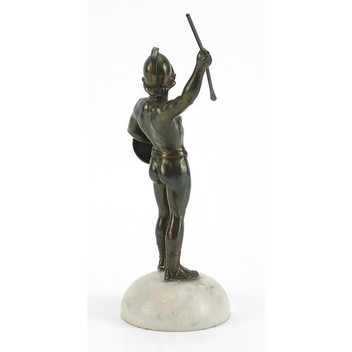 599 - Bronzed spelter figure of a Roman gladiator raised on a white marble base, 24cm high