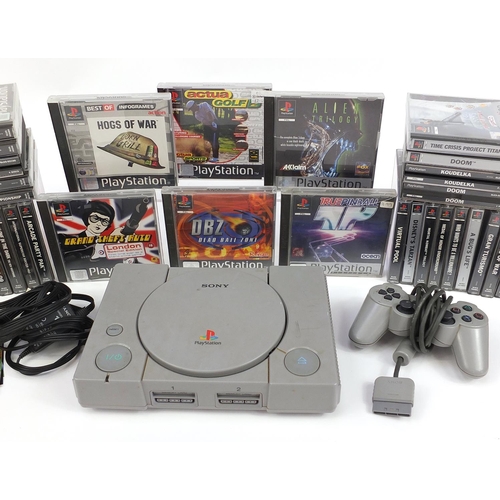 1182 - PlayStation 1 games console with controller and a large collection of games