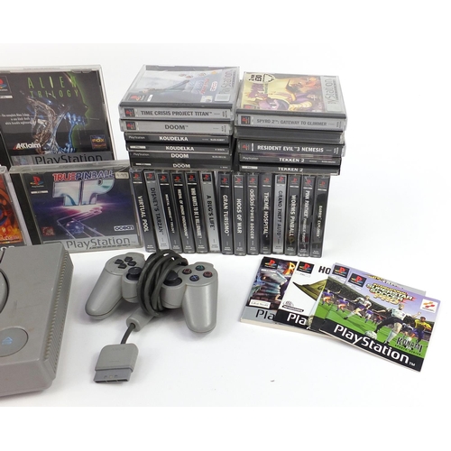 1182 - PlayStation 1 games console with controller and a large collection of games