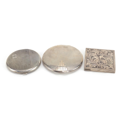 2125 - Three silver compacts including one Art Deco, the largest 8cm in diameter, total 196.2g