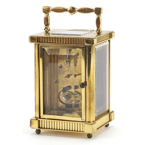 151 - St James brass cased carriage clock with enamelled dial having Roman numerals, 11.5cm high