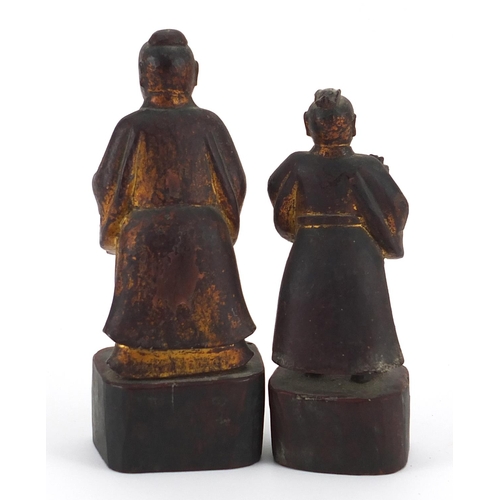 853 - Two Chinese partially gilt lacquered wood carvings of attendants, the largest 18.5cm high