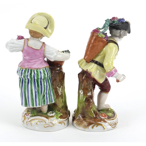 130 - Pair of Chelsea style porcelain figures with flowers, the largest 12.5cm high