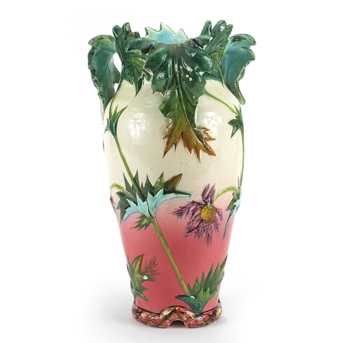 61 - Delphin Massier, French Vallauris three handled vase hand painted with flowers, 33.5cm high