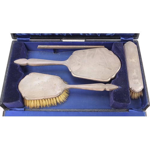 2132 - Silver objects comprising four piece dressing table set with fitted case, three napkin rings and two... 