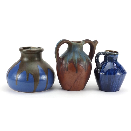 472 - Two Bourne Denby jugs including a spouted example and an Art Nouveau example with pewter overlay, th... 