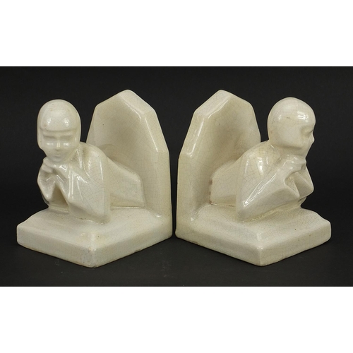 220 - Pair of Art Deco cream glazed bookends in the form of females, 10.5cm high