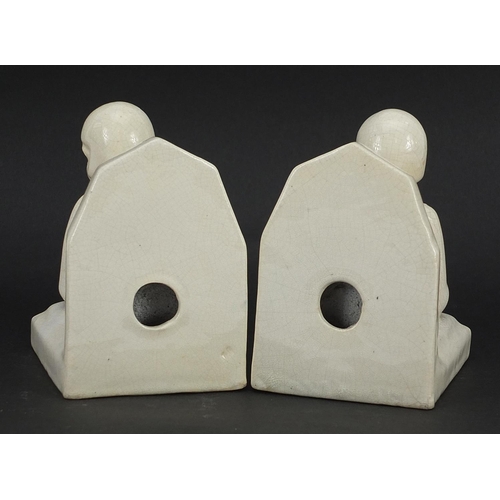 220 - Pair of Art Deco cream glazed bookends in the form of females, 10.5cm high