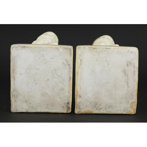 220 - Pair of Art Deco cream glazed bookends in the form of females, 10.5cm high