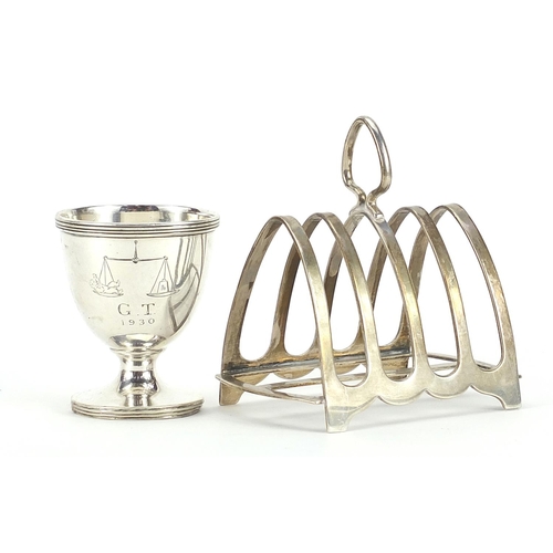 2124 - Silver four slice toast rack and silver eggcup, the largest 8.5cm wide, total 122.4g