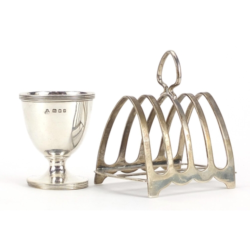 2124 - Silver four slice toast rack and silver eggcup, the largest 8.5cm wide, total 122.4g