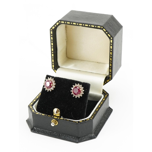 1409 - Pair of 9ct gold ruby and white sapphire stud earrings, 11mm in diameter, 2.8g