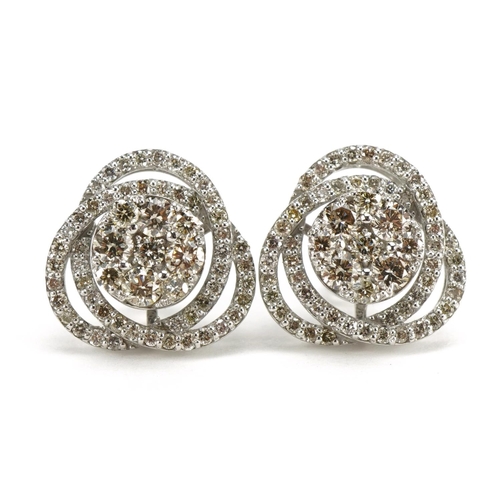 1405 - Pair of 18ct white gold swirling diamond cluster stud earrings, total diamond weight approximately 1... 