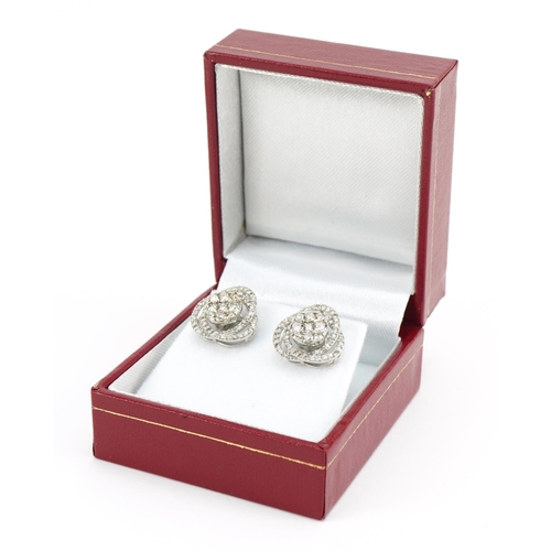 1405 - Pair of 18ct white gold swirling diamond cluster stud earrings, total diamond weight approximately 1... 