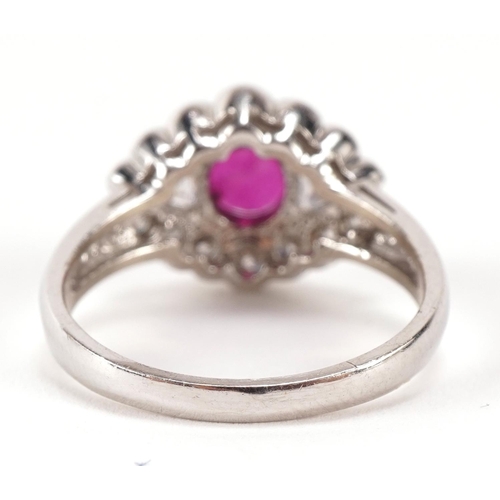 1418 - 14ct white gold ruby and diamond cluster ring, the ruby  5.70mm x 5.24mm, size N, 3.7g