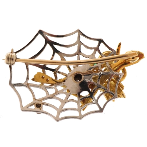 1416 - 18ct yellow and white gold bird and spider web brooch set with diamonds and an emerald, 4.5cm wide, ... 