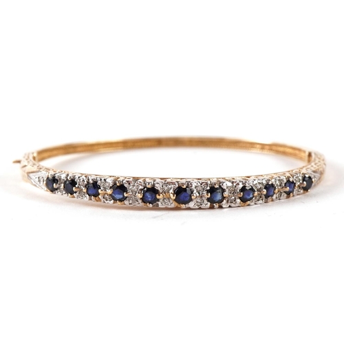 1421 - 9ct gold sapphire and diamond hinged bangle, the largest sapphire approximately 3.3mm in diameter  6... 