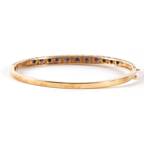 1421 - 9ct gold sapphire and diamond hinged bangle, the largest sapphire approximately 3.3mm in diameter  6... 