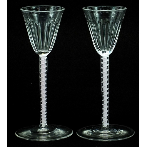 7 - Pair of antique wine glasses with opaque twist stems and facetted bowls, each 14.5cm high