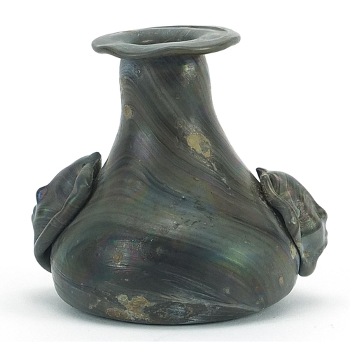 86 - Roman iridescent glass vase with figural handles, 7.5cm high