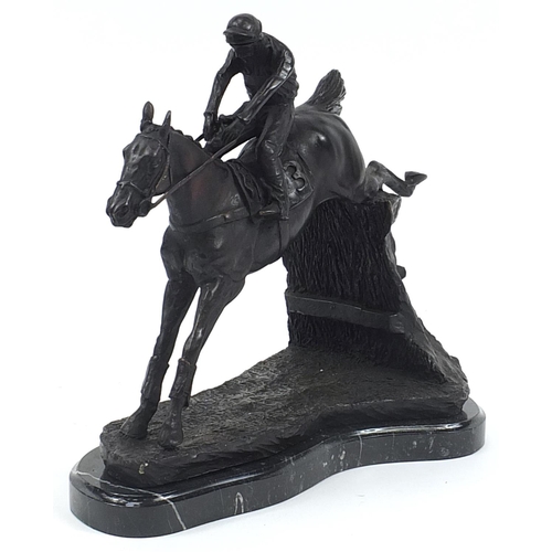 341 - Large patinated bronze jockey on horseback raised on a black marble base, 35cm in length