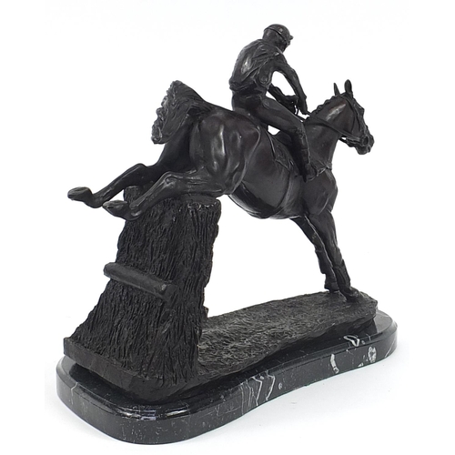 341 - Large patinated bronze jockey on horseback raised on a black marble base, 35cm in length