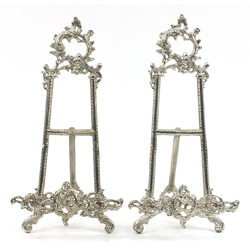 540 - Pair of Rococo style silvered metal easel stands, 40cm high