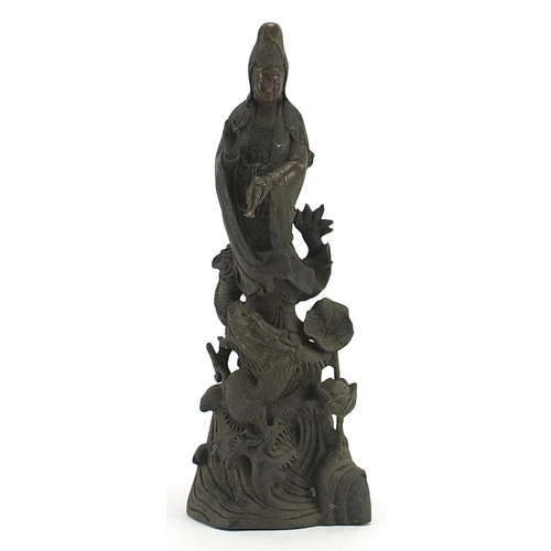 504 - Chinese patinated bronze figure of Guan Yin with a dragon, 36cm high