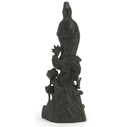 504 - Chinese patinated bronze figure of Guan Yin with a dragon, 36cm high