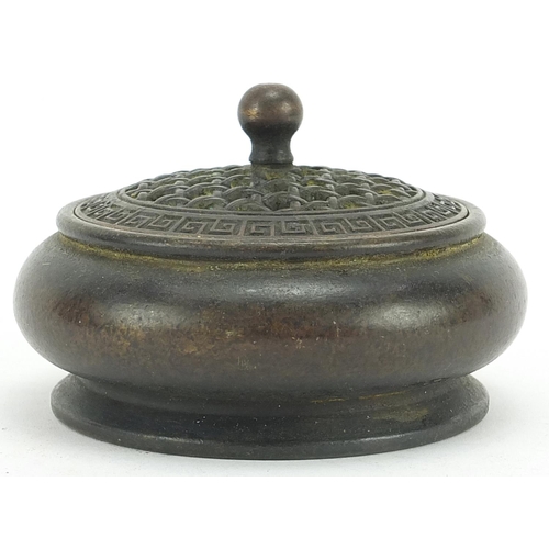 552 - Chinese patinated bronze censer with pierced cover, 9.5cm in diameter