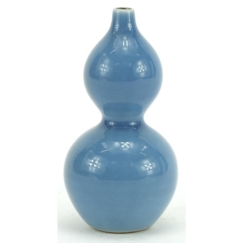 598 - Chinese porcelain double gourd vase having a blue glaze, character marks to the base, 11cm high