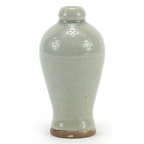 588 - Chinese porcelain baluster shaped vase having a celadon glaze, 13cm high