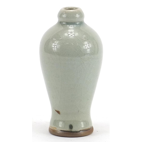 588 - Chinese porcelain baluster shaped vase having a celadon glaze, 13cm high