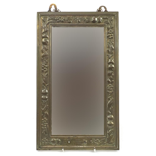627 - Rectangular brass framed wall hanging mirror embossed with fruit, with bevelled glass, 38cm x 23cm